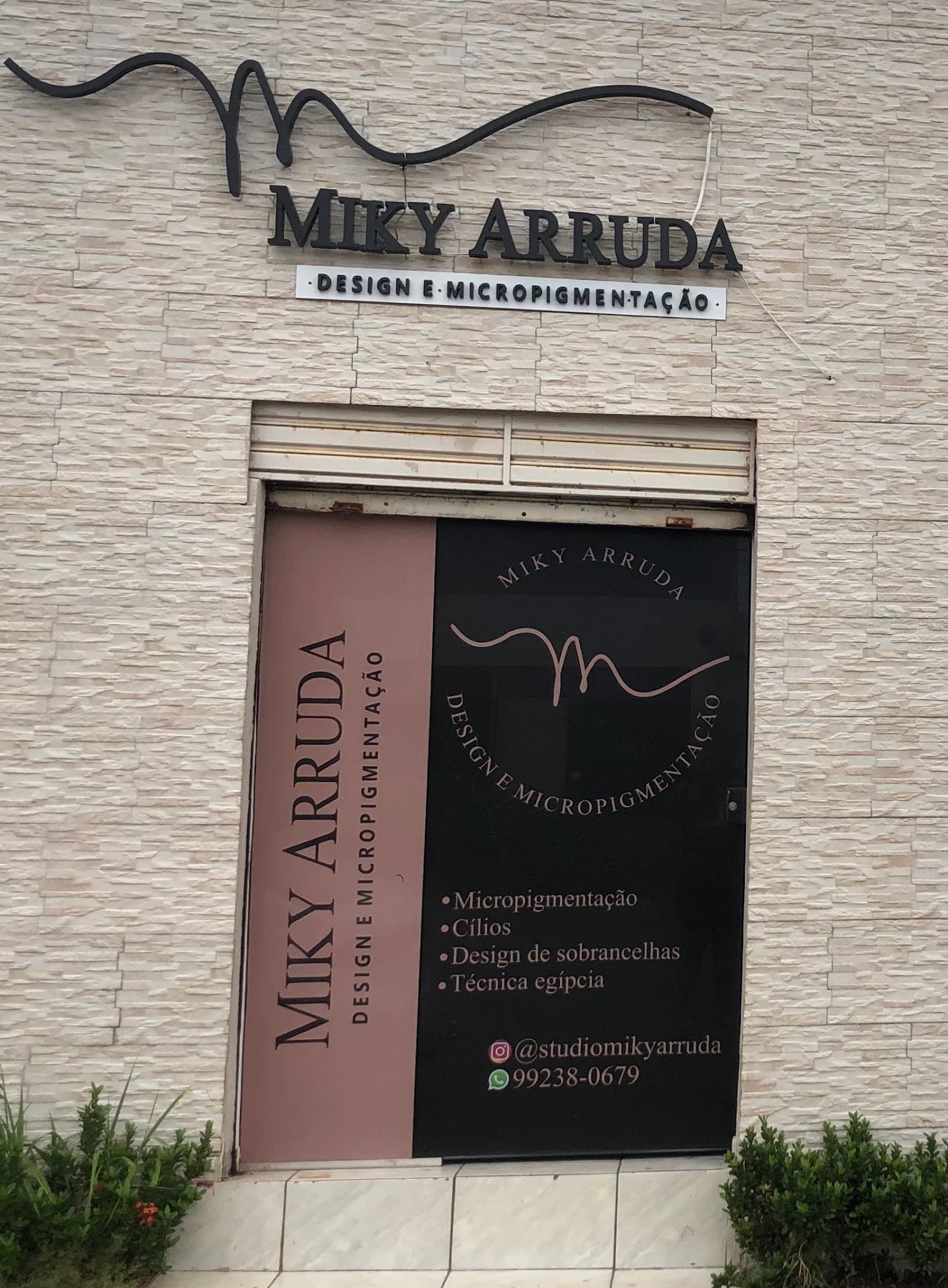 Fachada do Studio Miky Arruda, em pedra clara, com letreiro Design e Micropigmentação